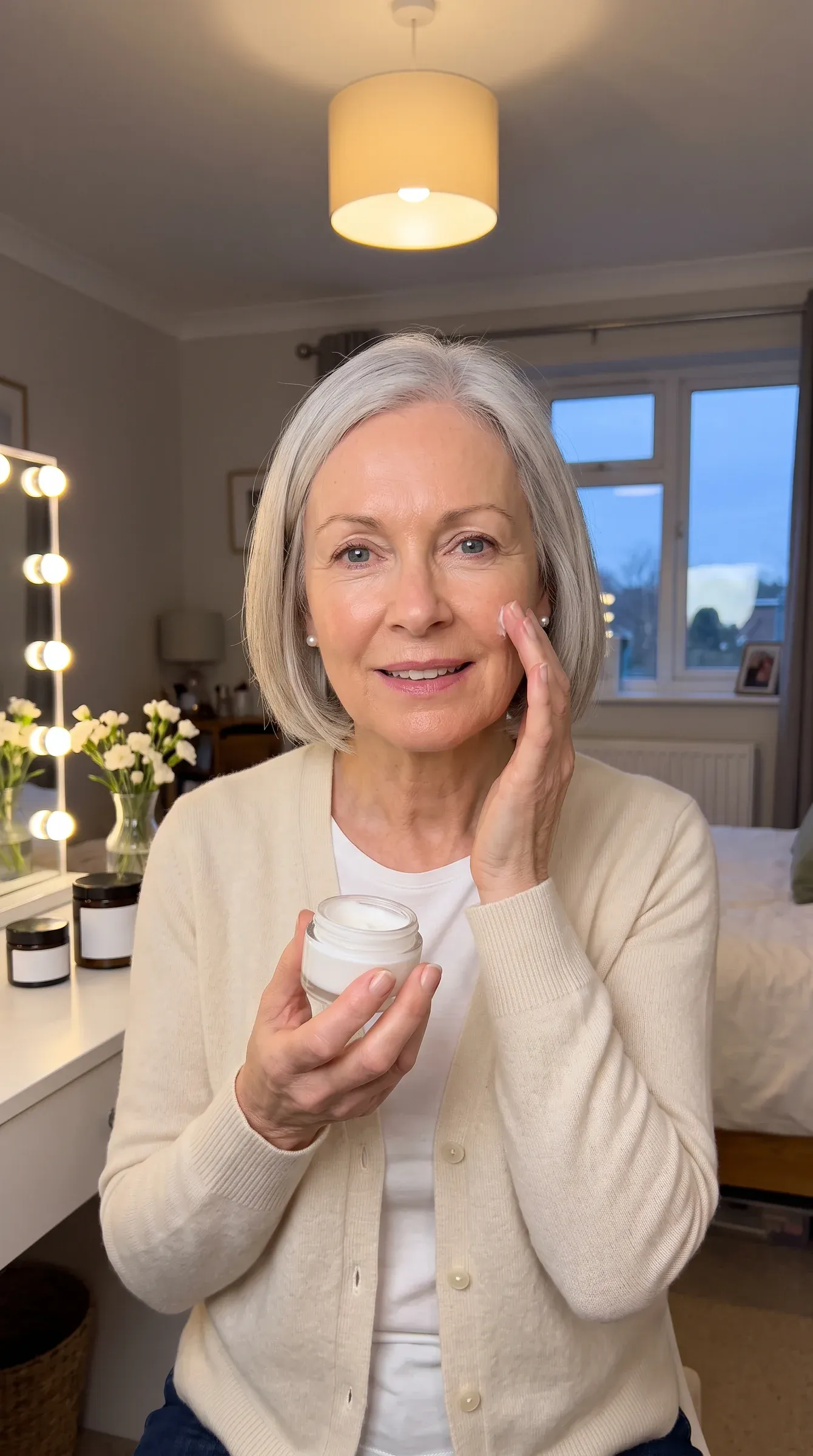 Skincare reel: a woman in her sixties smooths night cream on her cheek